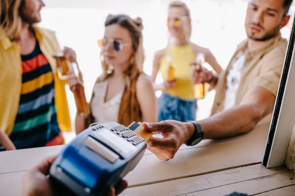 person paying with credit card during the summer