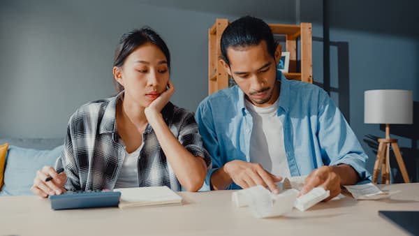 couple looks at budget managing debt and money
